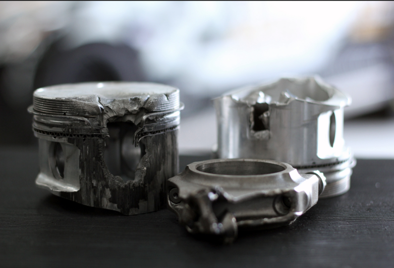 Damaged piston and connecting rods from a performance engine