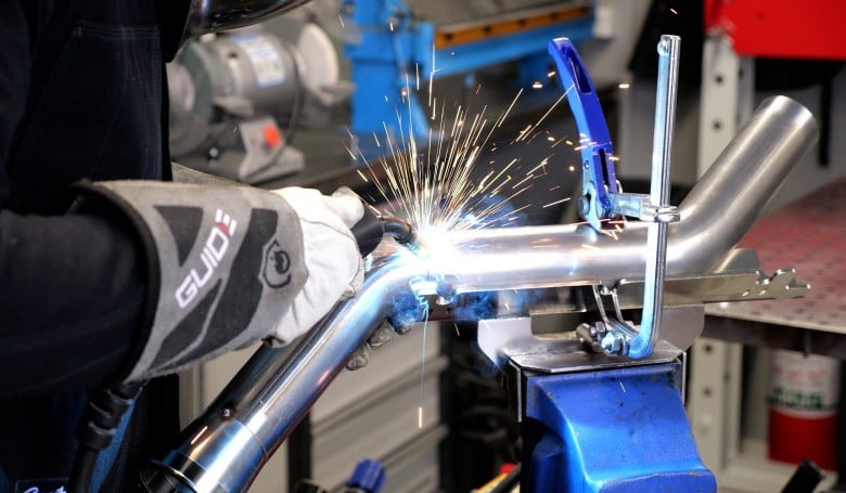 MIG welding in action on a motorsport chassis fabrication project
