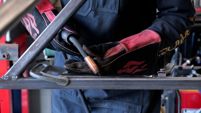 Welder demonstrating correct MIG welding technique and torch position