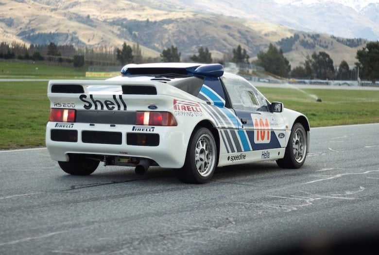 Performance car being driven on a road during a road tuning session