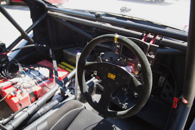 inside pikes peak hill climb car cockpit showing steering wheel and gearshifter