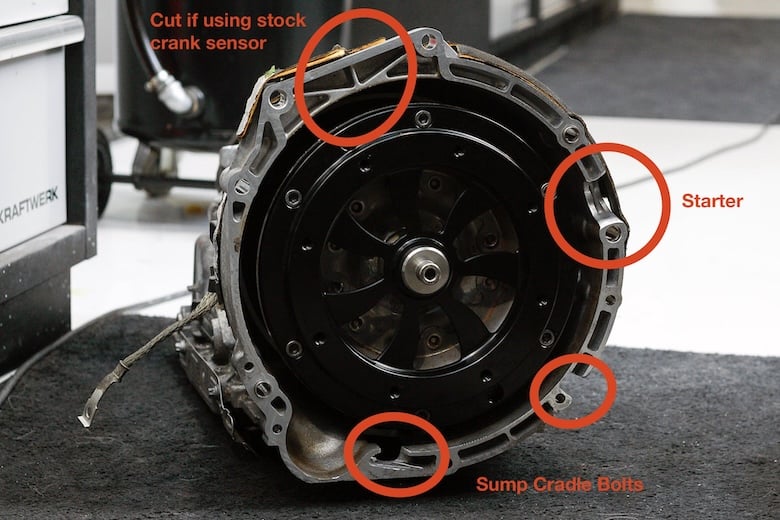 ZF 8HP bellhousing with starter motor and sump cradle bolt clearance areas marked.