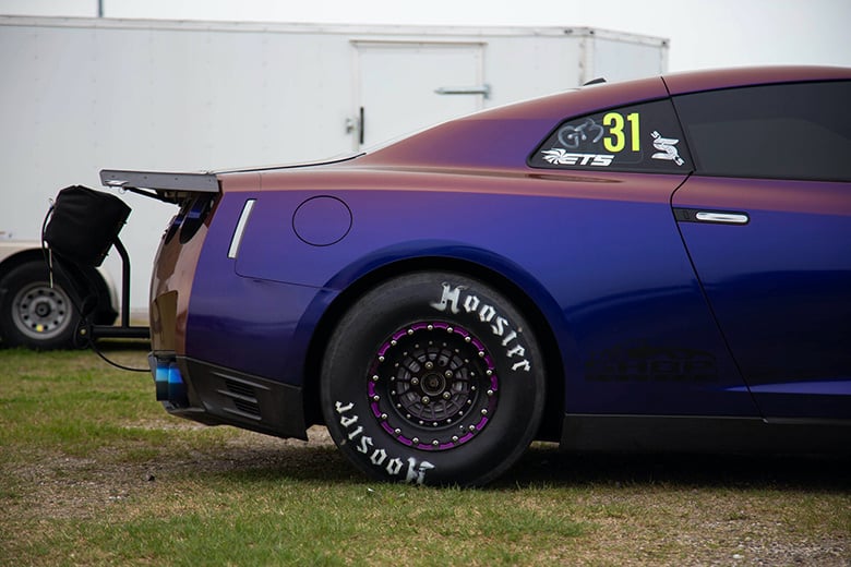 Drag racing slick tyre showing tall sidewall profile subject to tyre growth under launch conditions