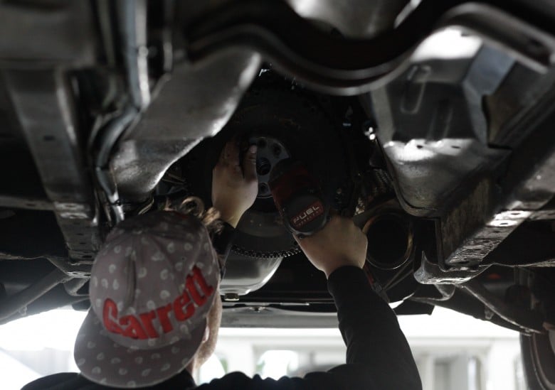 mechanic-working-on-flywheel-during-transmission-swap