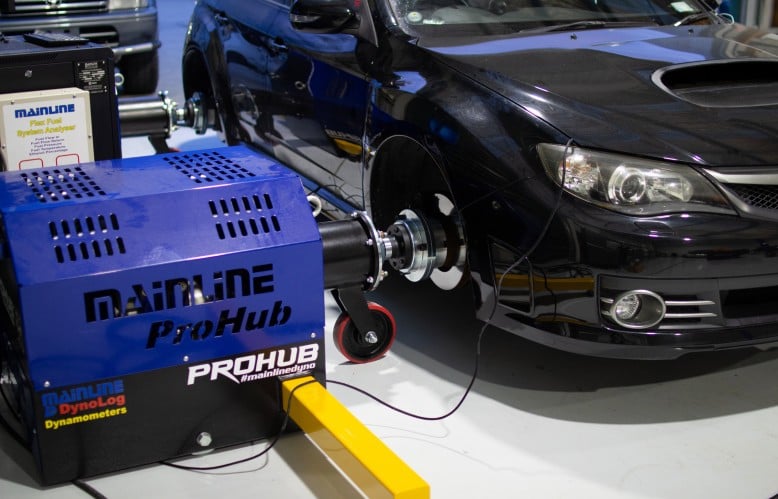 Tuner with a laptop working through a road tune on a performance vehicle