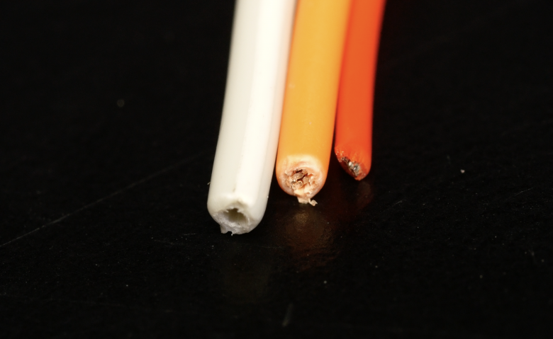 Wire Types Comparison of different automotive wire types including PVC, TXL, Spec 44 and Tefzel used in motorsport wiring